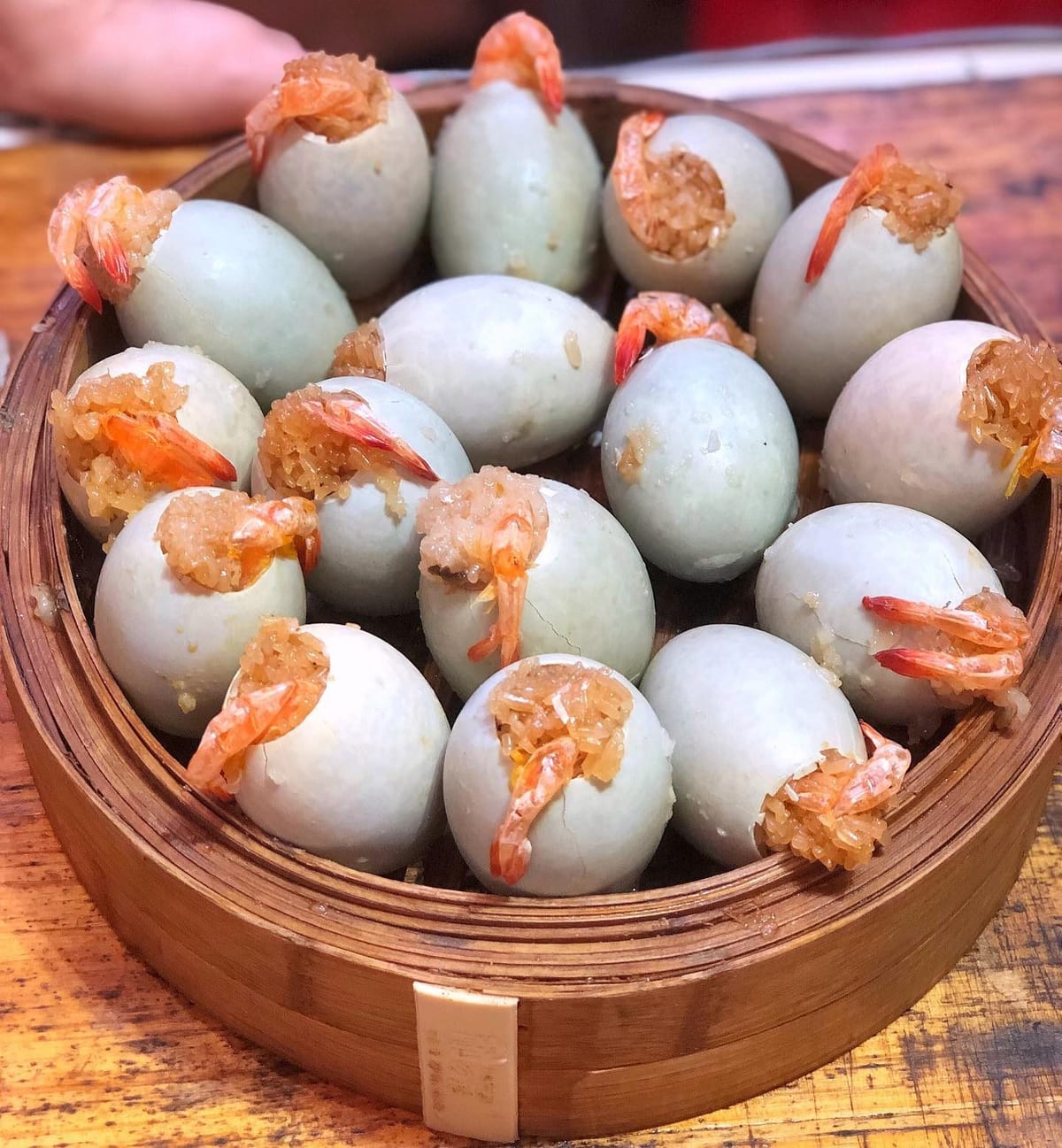 They stuff glutinous rice and a salted egg yolk into the empty egg